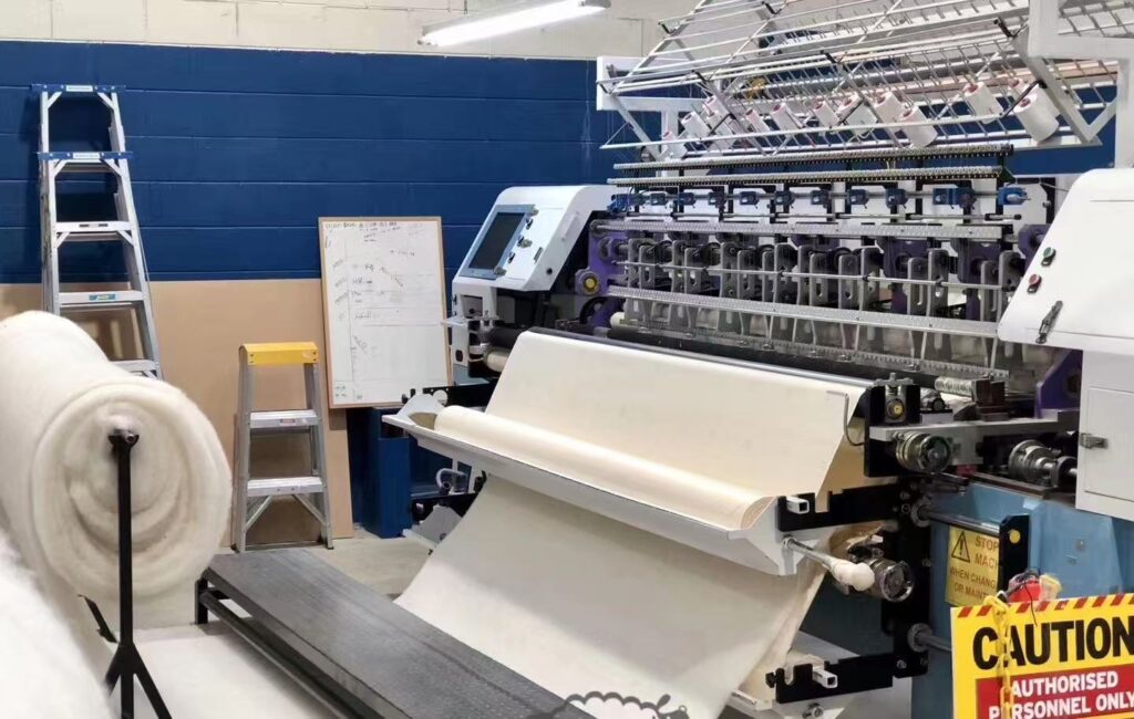 High-speed multi-needle machine  for mass-producing duvets.